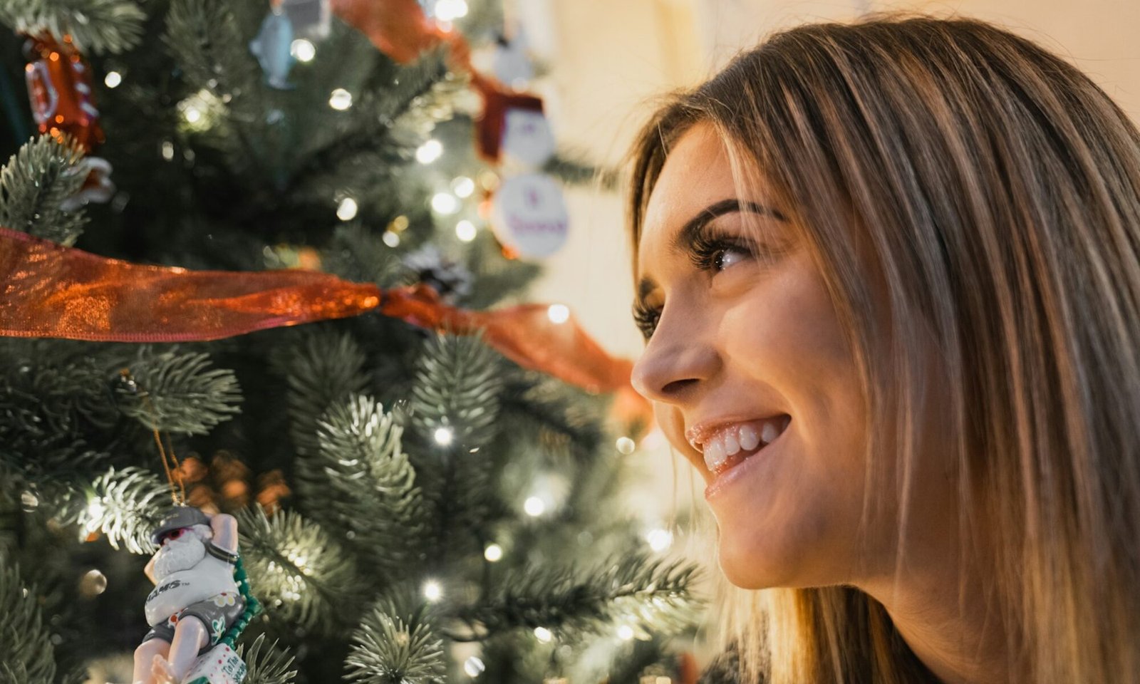 smiling woman near green Christmas tree