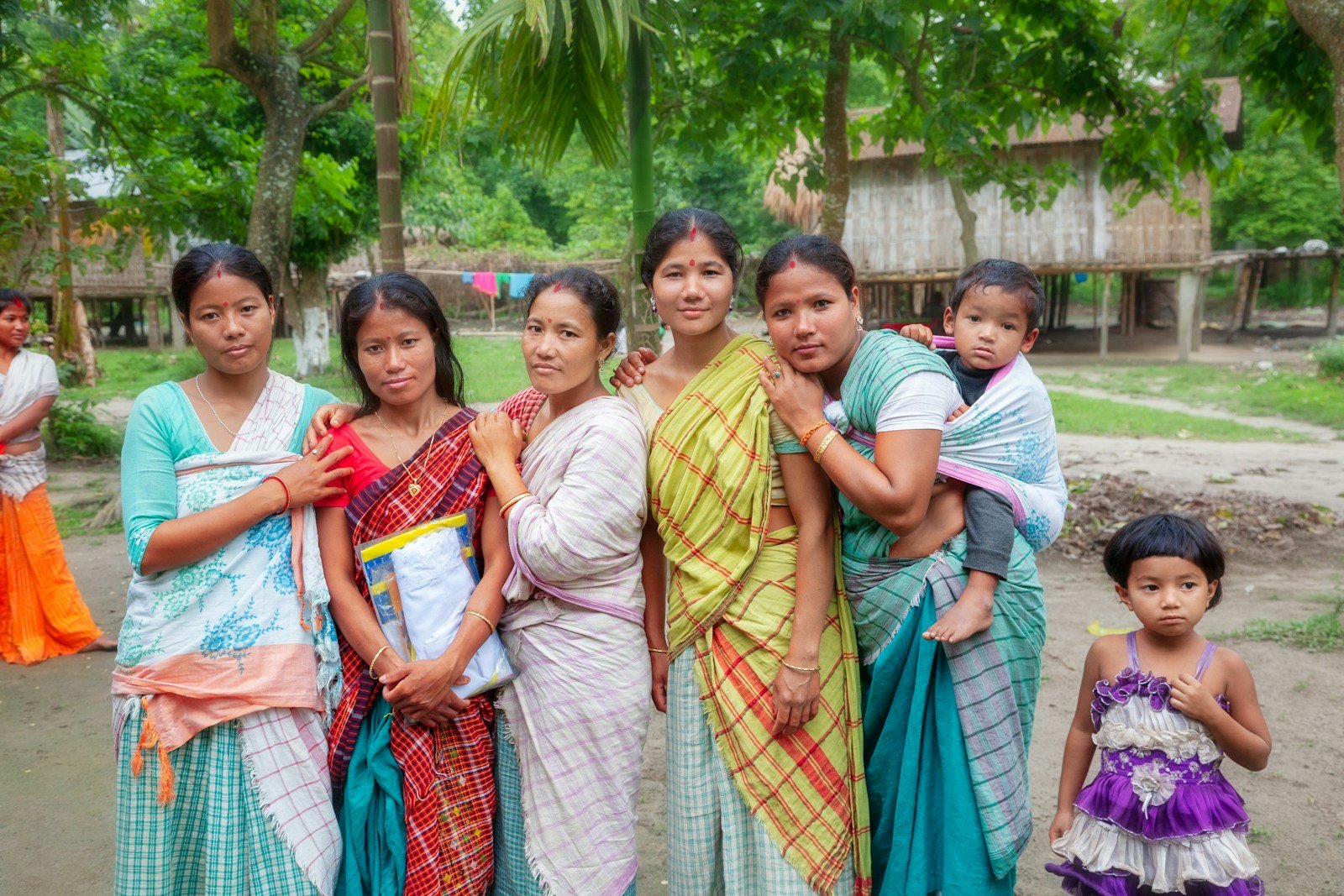 Group of women and children in a rural village setting